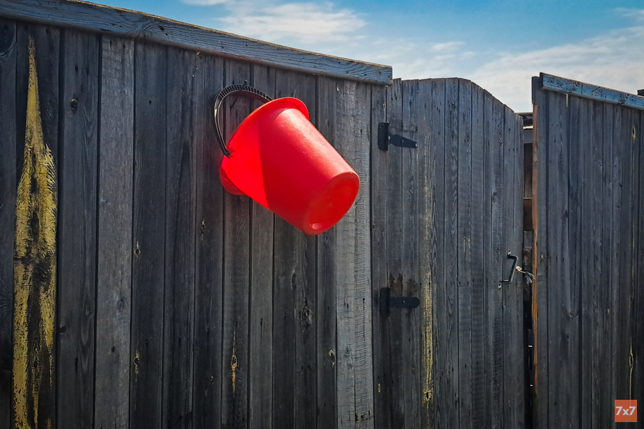 If you don't hang a bucket in front of your house, the water truck will drive by. Photo 7x7